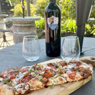 top view of bottle of red wine on wooden tabletop with copy space